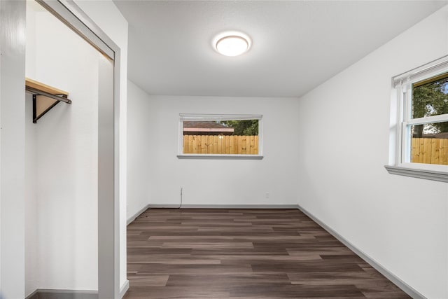 9211 Helmers St, Houston, TX 77022 - unfurnished bedroom featuring dark wood-style flooring and baseboards