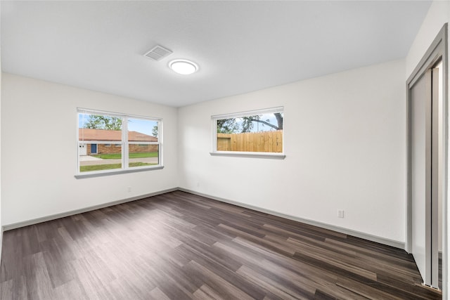 9211 Helmers St, Houston, TX 77022 - unfurnished bedroom featuring baseboards, a closet, dark wood finished floors, and visible vents