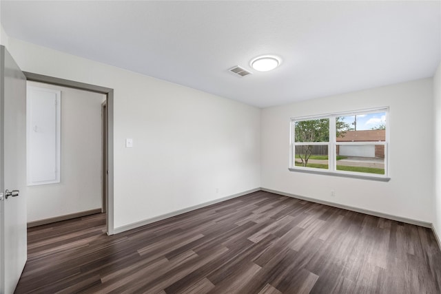 9211 Helmers St, Houston, TX 77022 - spare room featuring dark wood finished floors, visible vents, and baseboards