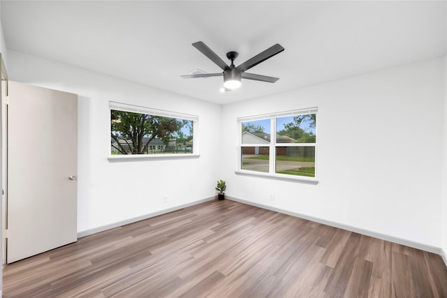 9211 Helmers St, Houston, TX 77022 - unfurnished room with wood finished floors, baseboards, and ceiling fan