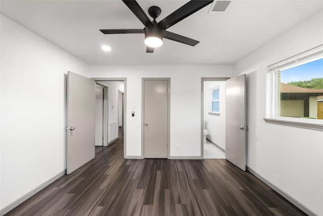 9211 Helmers St, Houston, TX 77022 - unfurnished bedroom with a ceiling fan, baseboards, dark wood finished floors, visible vents, and connected bathroom