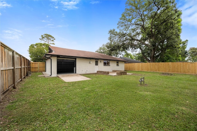 9211 Helmers St, Houston, TX 77022 - rear view of house with a lawn, a patio area, and a fenced backyard