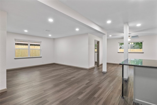 9211 Helmers St, Houston, TX 77022 - unfurnished living room featuring a ceiling fan, dark wood-type flooring, baseboards, visible vents, and recessed lighting