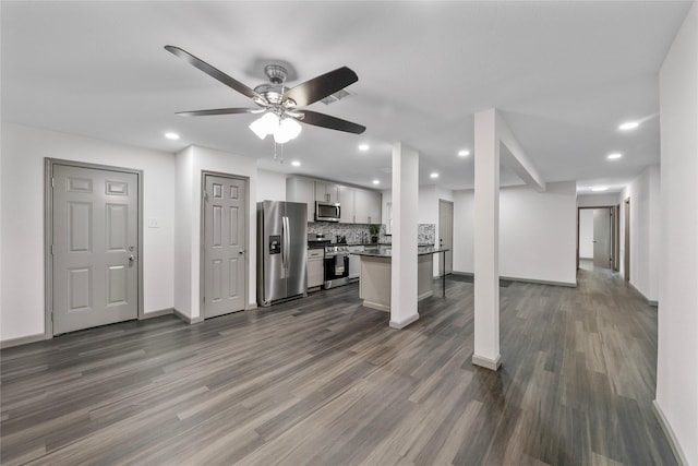 9211 Helmers St, Houston, TX 77022 - unfurnished living room featuring ceiling fan, baseboards, dark wood-type flooring, and recessed lighting
