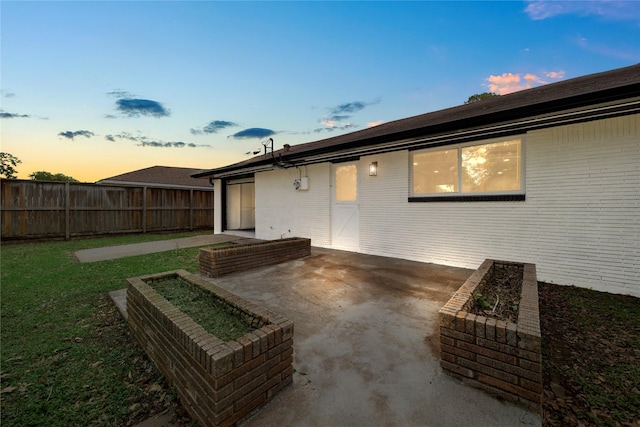 9211 Helmers St, Houston, TX 77022 - back of property featuring a lawn, fence, a patio area, and brick siding