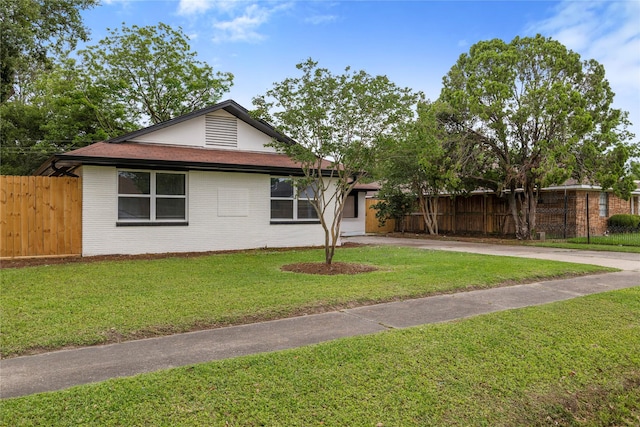 9211 Helmers St, Houston, TX 77022 - single story home featuring brick siding, driveway, fence, and a front yard