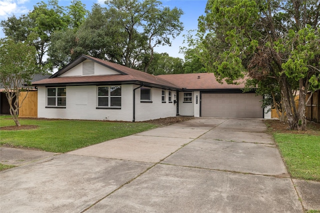 9211 Helmers St, Houston, TX 77022 - single story home with fence, brick siding, driveway, a garage, and a front yard