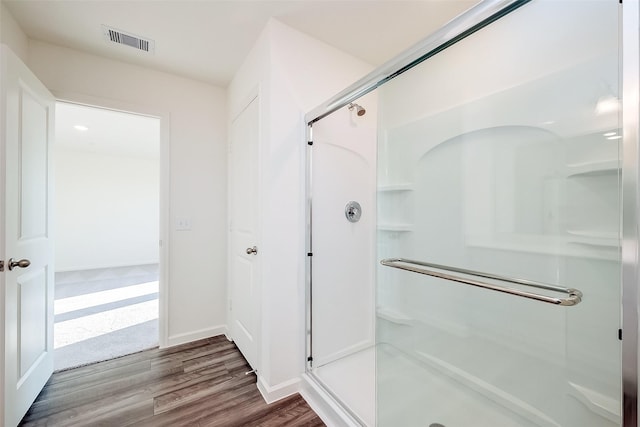5811 Capri Forest Dr, Katy, TX 77493 - bathroom with a shower stall, wood finished floors, and baseboards
