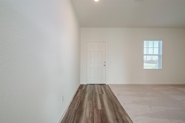 5811 Capri Forest Dr, Katy, TX 77493 - spare room featuring baseboards and dark wood-style floors