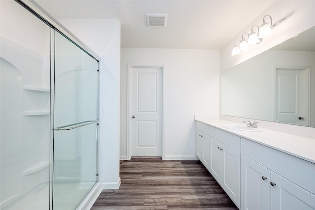 5811 Capri Forest Dr, Katy, TX 77493 - full bathroom featuring a stall shower, wood finished floors, vanity, and baseboards