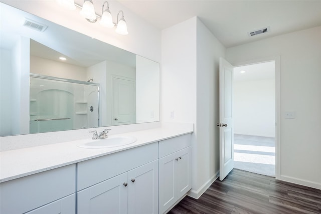 5811 Capri Forest Dr, Katy, TX 77493 - full bath with wood finished floors, vanity, a shower stall, baseboards, and recessed lighting
