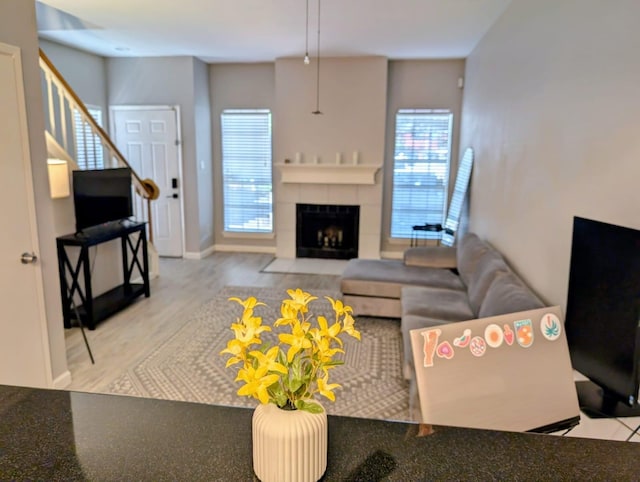 2626 Holly Hall St Unit 1201, Houston, TX 77054 - living area featuring a fireplace, wood finished floors, and stairway