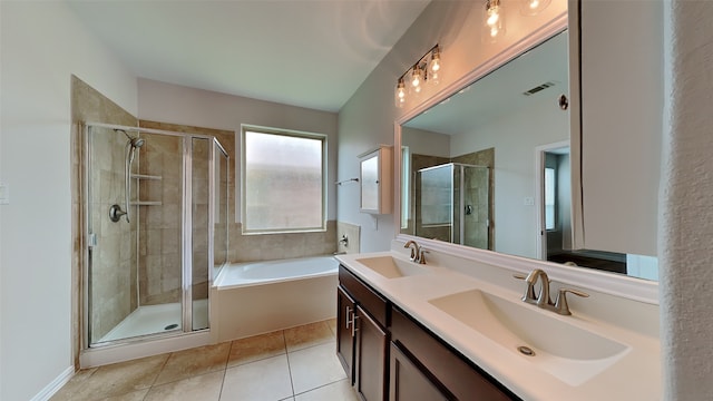 bathroom featuring a sink, a stall shower, visible vents, and tile patterned floors