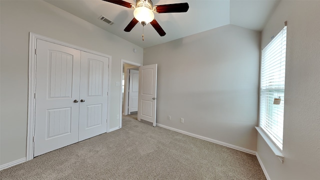 unfurnished bedroom with carpet floors, a closet, visible vents, and multiple windows