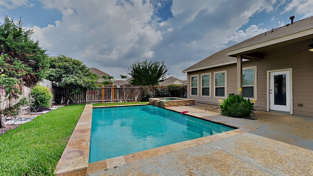 view of swimming pool with a yard, a patio area, a pool with connected hot tub, and a fenced backyard
