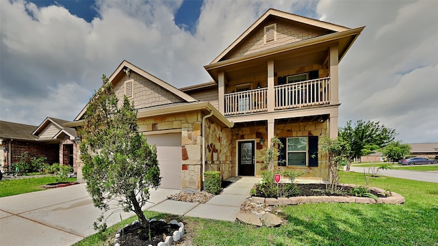 craftsman-style home with a balcony, driveway, a garage, stone siding, and a front lawn