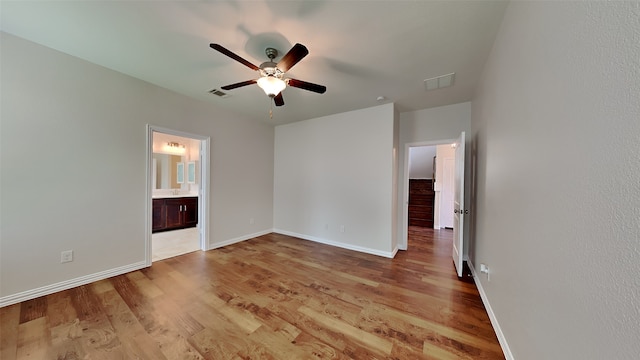 unfurnished bedroom featuring baseboards, light wood-type flooring, and visible vents