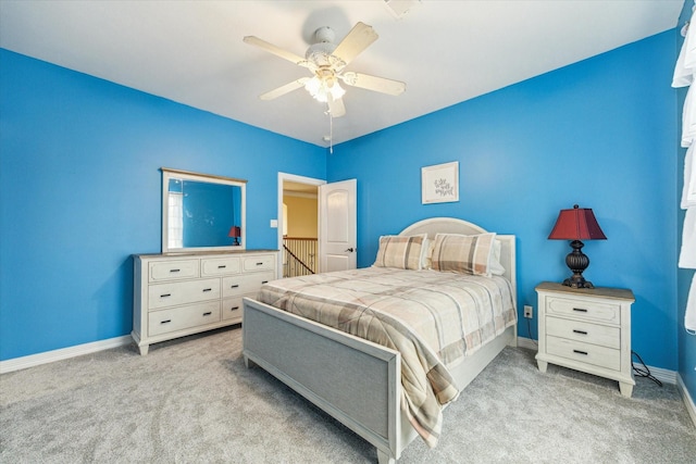 carpeted bedroom with baseboards and a ceiling fan