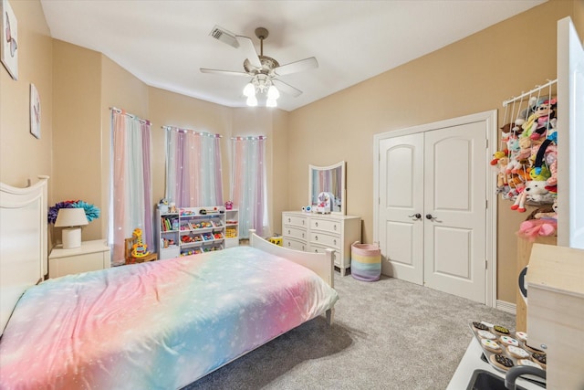 carpeted bedroom featuring a closet and ceiling fan