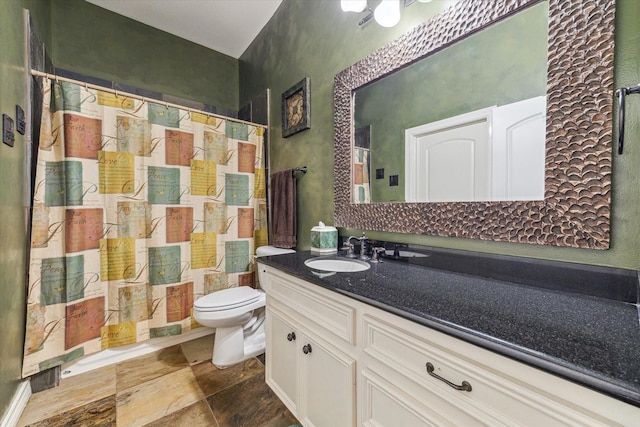 full bathroom with toilet, vanity, curtained shower, and stone finish flooring