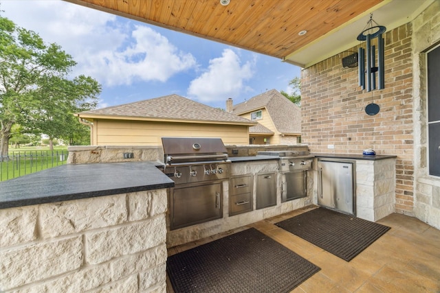 view of patio featuring area for grilling, grilling area, and fence