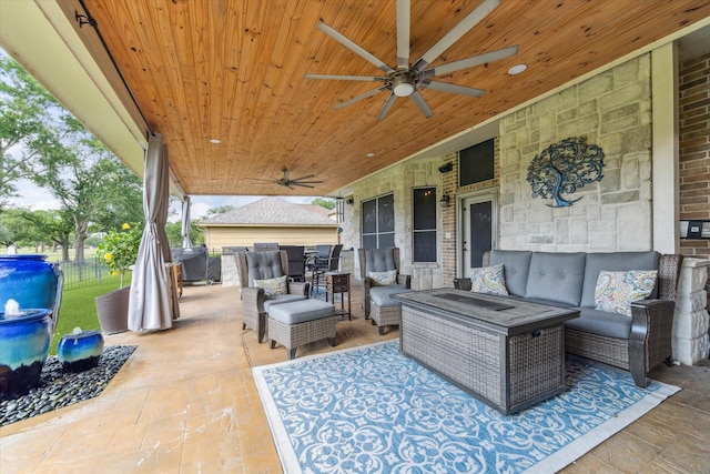 view of patio / terrace with an outdoor living space, ceiling fan, and fence