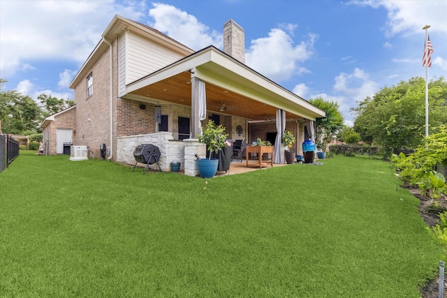 rear view of house with a patio, a chimney, cooling unit, brick siding, and ceiling fan