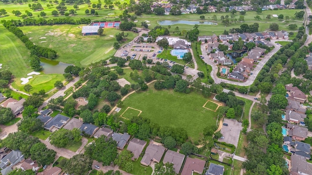 view of property location with nearby suburban area, a large body of water, and a local golf course