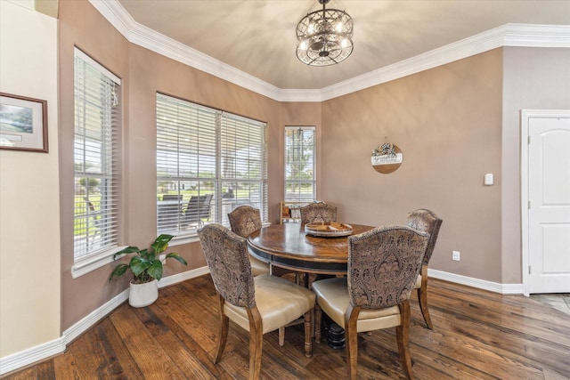 dining room with wood finished floors, baseboards, a chandelier, and crown molding