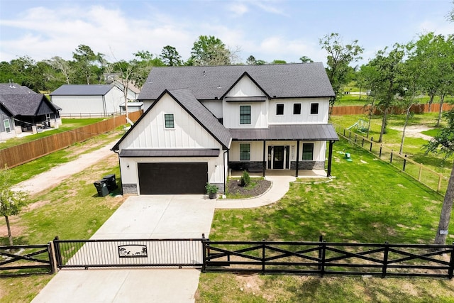 24585 Tipperary St, Hempstead, TX 77445 - modern inspired farmhouse featuring board and batten siding, a fenced front yard, a porch, driveway, and a standing seam roof
