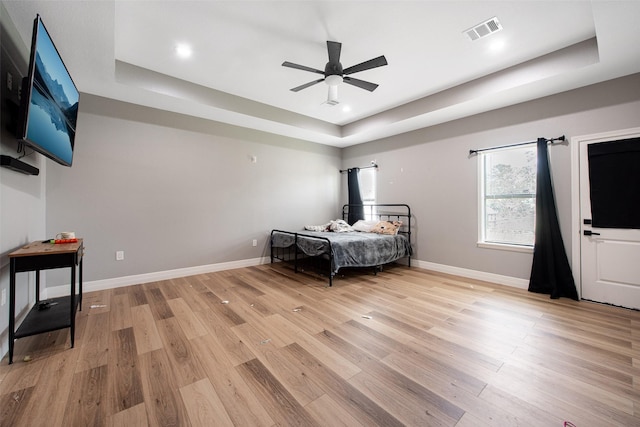 24585 Tipperary St, Hempstead, TX 77445 - bedroom with baseboards, a raised ceiling, light wood-style flooring, and visible vents