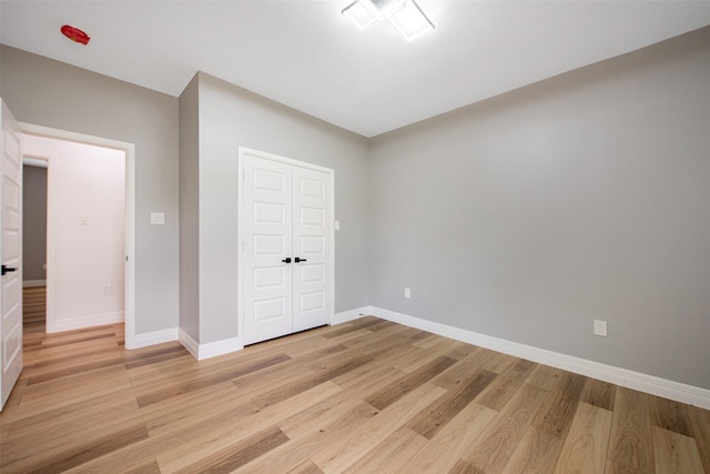 24585 Tipperary St, Hempstead, TX 77445 - unfurnished bedroom with a closet, light wood-type flooring, and baseboards