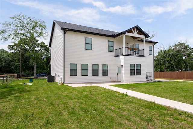 24585 Tipperary St, Hempstead, TX 77445 - back of property with central AC, fence, a lawn, and a balcony