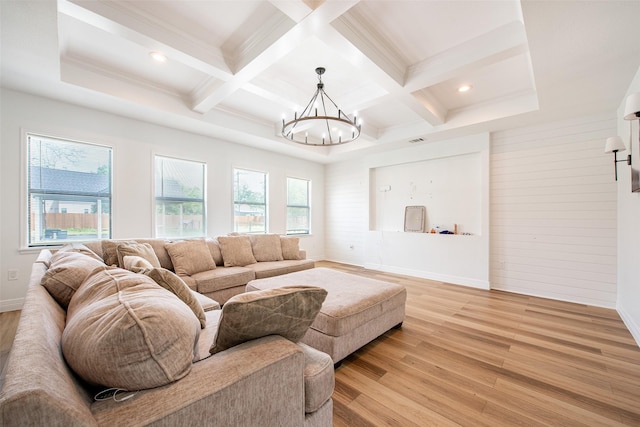 24585 Tipperary St, Hempstead, TX 77445 - living room with a notable chandelier, light wood-style floors, beam ceiling, and coffered ceiling