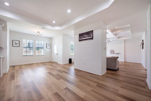 24585 Tipperary St, Hempstead, TX 77445 - unfurnished living room featuring a tray ceiling, light wood-style flooring, and recessed lighting