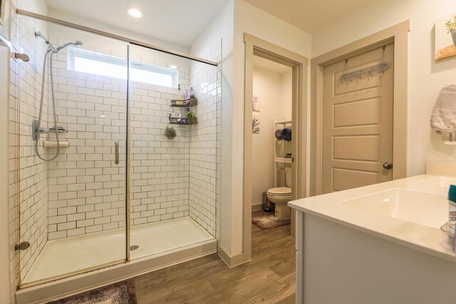 1830 William Scott St, Baytown, TX 77523 - bathroom featuring a stall shower, recessed lighting, toilet, vanity, and wood finished floors