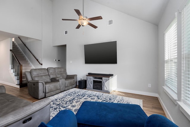 17828 Hanson Ridge Dr, Conroe, TX 77316 - living room featuring a ceiling fan, plenty of natural light, stairway, wood finished floors, and high vaulted ceiling