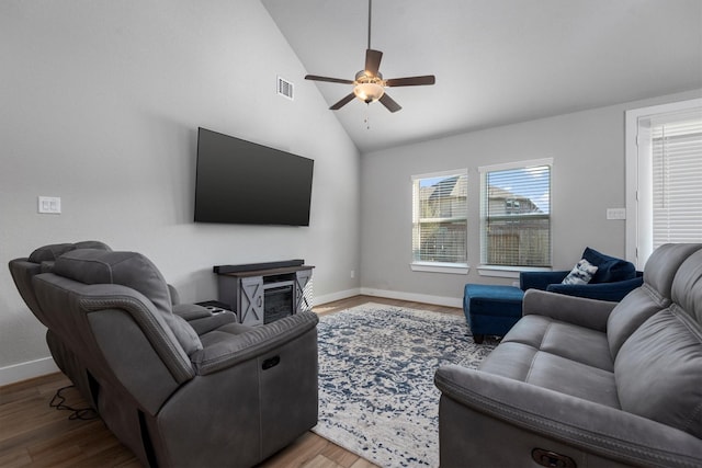 17828 Hanson Ridge Dr, Conroe, TX 77316 - living room featuring a ceiling fan, baseboards, a glass covered fireplace, wood finished floors, and high vaulted ceiling