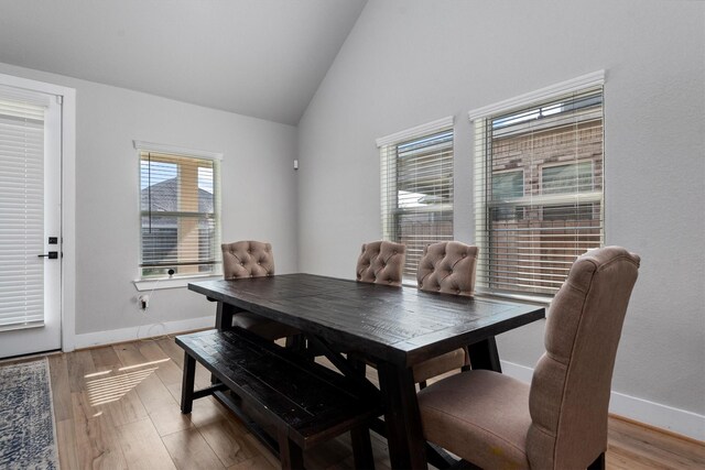 17828 Hanson Ridge Dr, Conroe, TX 77316 - dining space with lofted ceiling, baseboards, and light wood finished floors