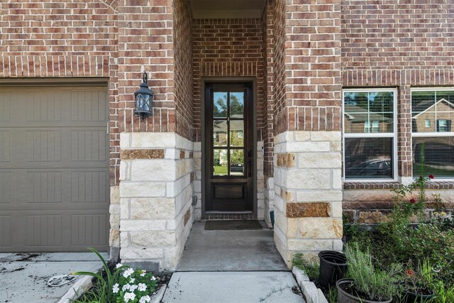 17828 Hanson Ridge Dr, Conroe, TX 77316 - entrance to property featuring brick siding, a garage, and stone siding