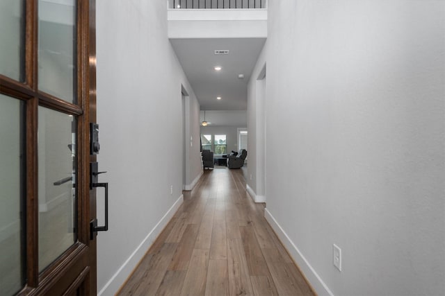 17828 Hanson Ridge Dr, Conroe, TX 77316 - hall with light wood-style flooring, baseboards, and recessed lighting