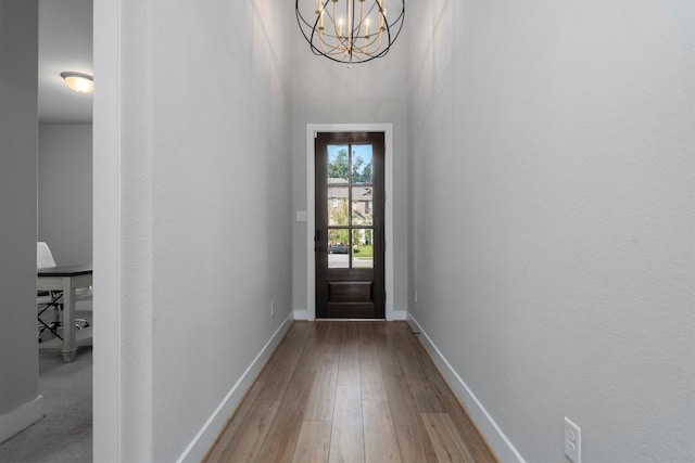 17828 Hanson Ridge Dr, Conroe, TX 77316 - doorway featuring wood finished floors, a chandelier, baseboards, and a towering ceiling