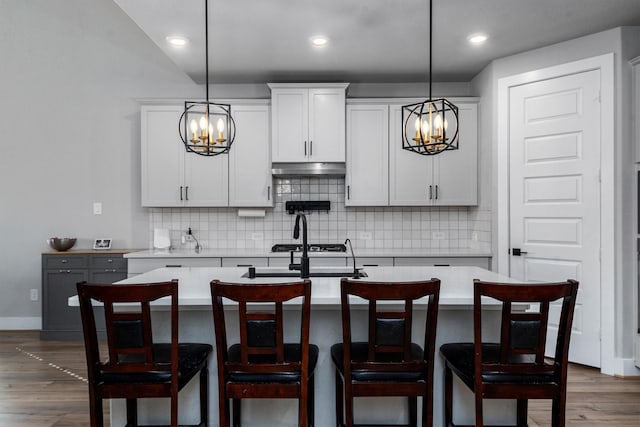17828 Hanson Ridge Dr, Conroe, TX 77316 - kitchen featuring a chandelier, light countertops, a center island with sink, and recessed lighting