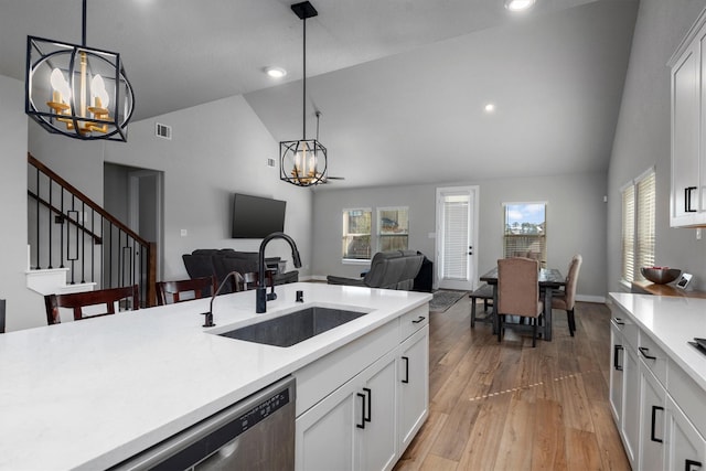17828 Hanson Ridge Dr, Conroe, TX 77316 - kitchen with a sink, a chandelier, open floor plan, high vaulted ceiling, and light countertops