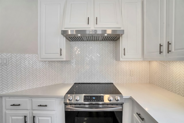 17422 Marigold Dr, Sugar Land, TX 77479 - kitchen featuring electric range, ventilation hood, light countertops, and white cabinets