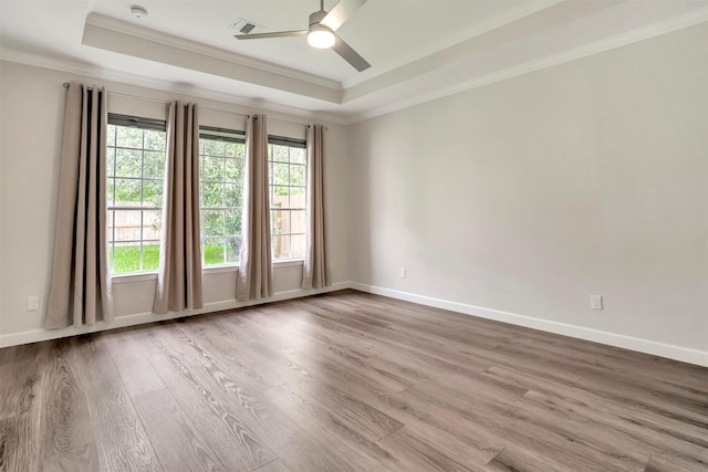 17422 Marigold Dr, Sugar Land, TX 77479 - empty room with a raised ceiling, ornamental molding, wood finished floors, and a ceiling fan