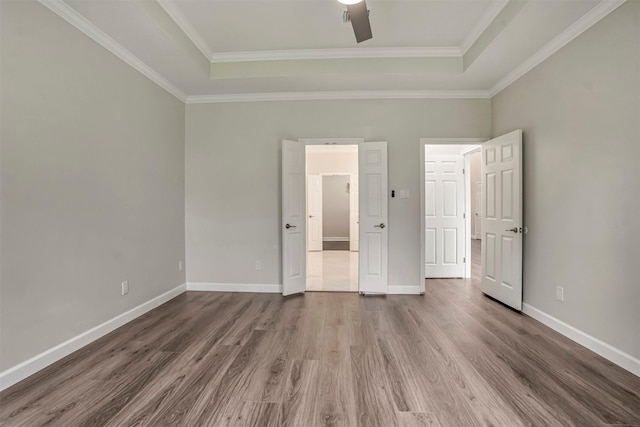 17422 Marigold Dr, Sugar Land, TX 77479 - unfurnished bedroom featuring a tray ceiling, wood finished floors, baseboards, ornamental molding, and ceiling fan