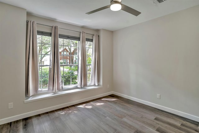 17422 Marigold Dr, Sugar Land, TX 77479 - spare room with baseboards, a ceiling fan, and wood finished floors