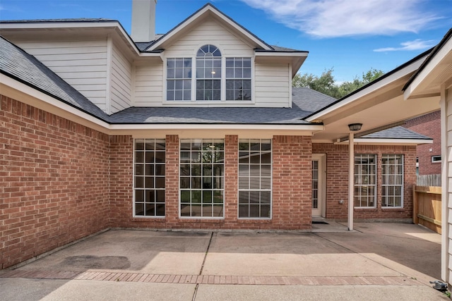 17422 Marigold Dr, Sugar Land, TX 77479 - back of house featuring a patio, brick siding, a shingled roof, and fence