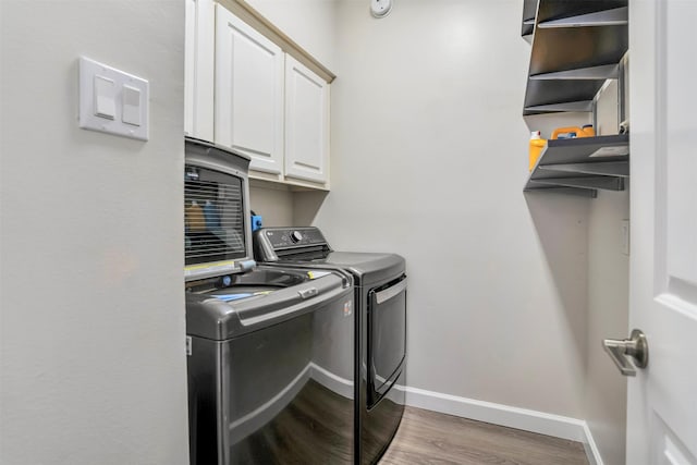 17422 Marigold Dr, Sugar Land, TX 77479 - clothes washing area featuring cabinet space, separate washer and dryer, wood finished floors, and baseboards